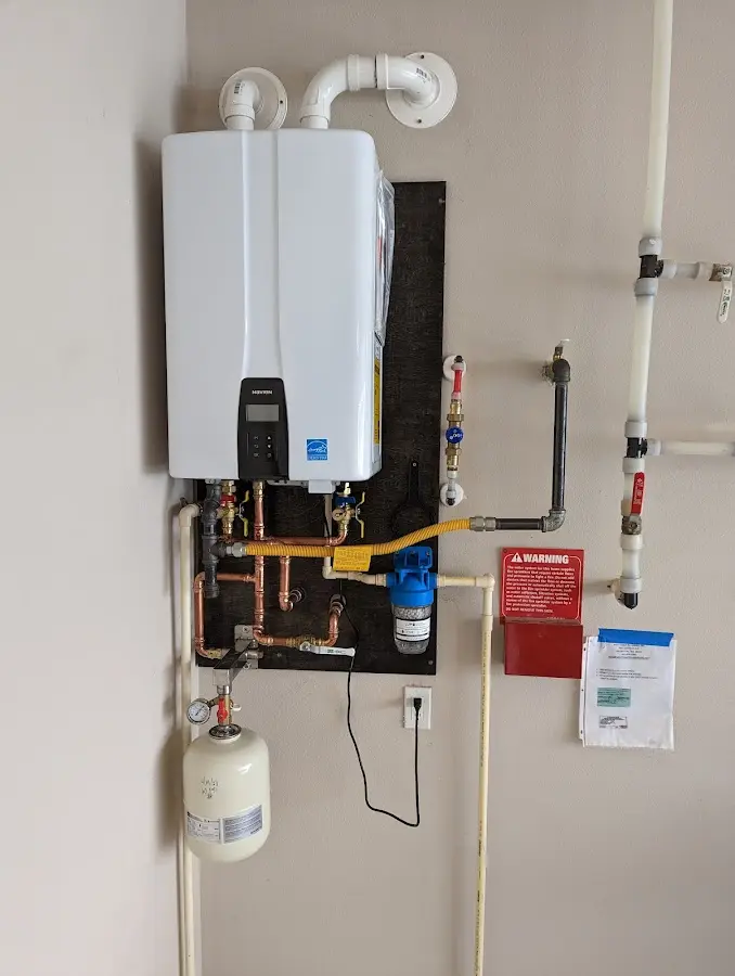 Professional plumber installing copper piping in a Lindenhurst home